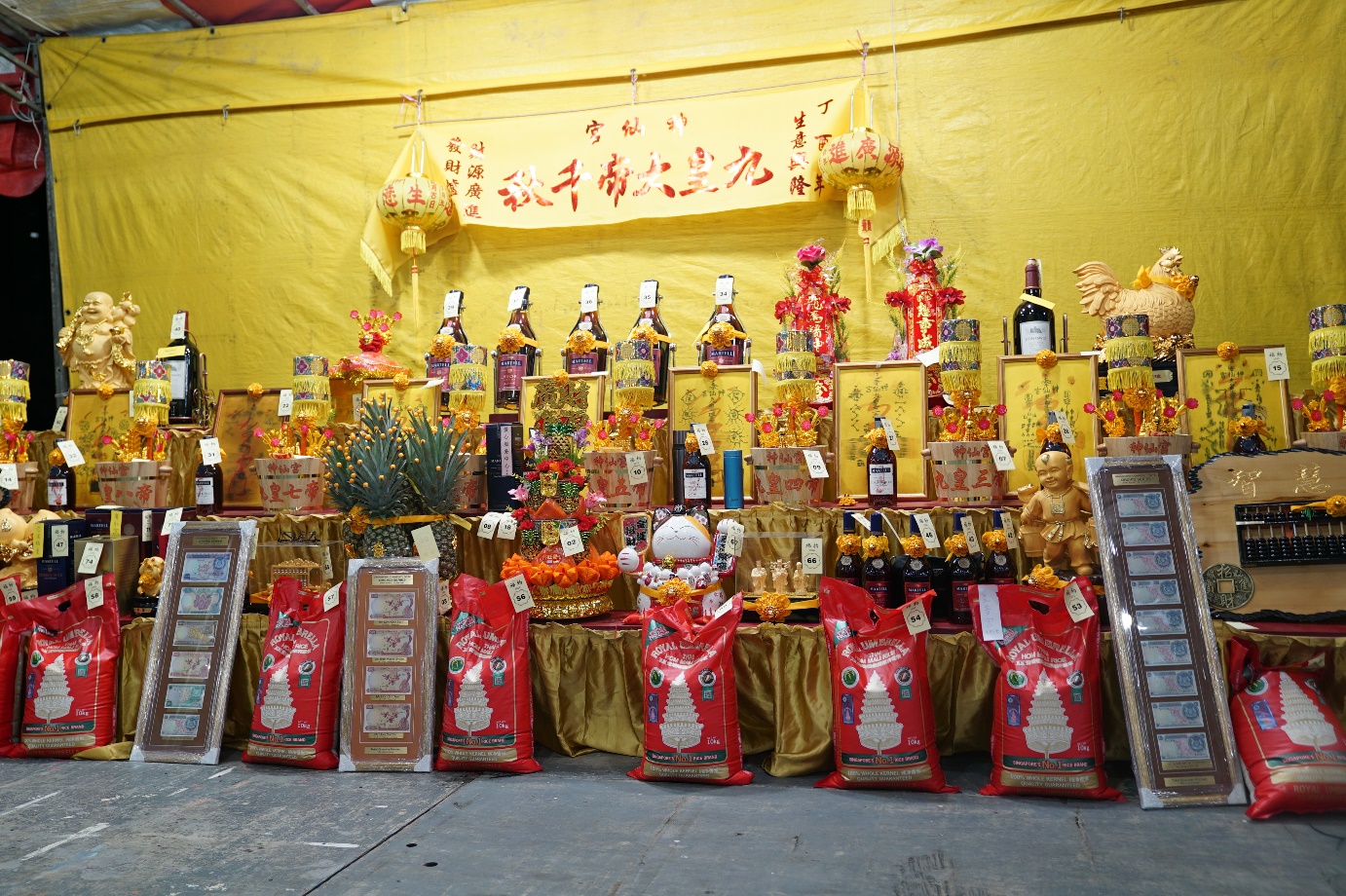 The items up for auctions include wine, talisman, rice bucket, rice packs and many other auspicious items.
